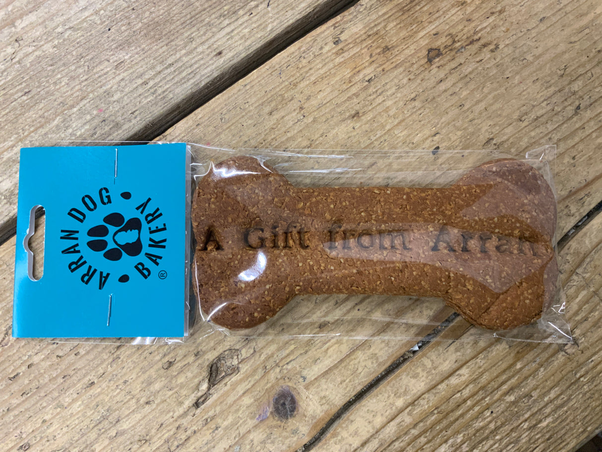 Arran Dog bone-shaped dog biscuit with packaging on a wooden surface
