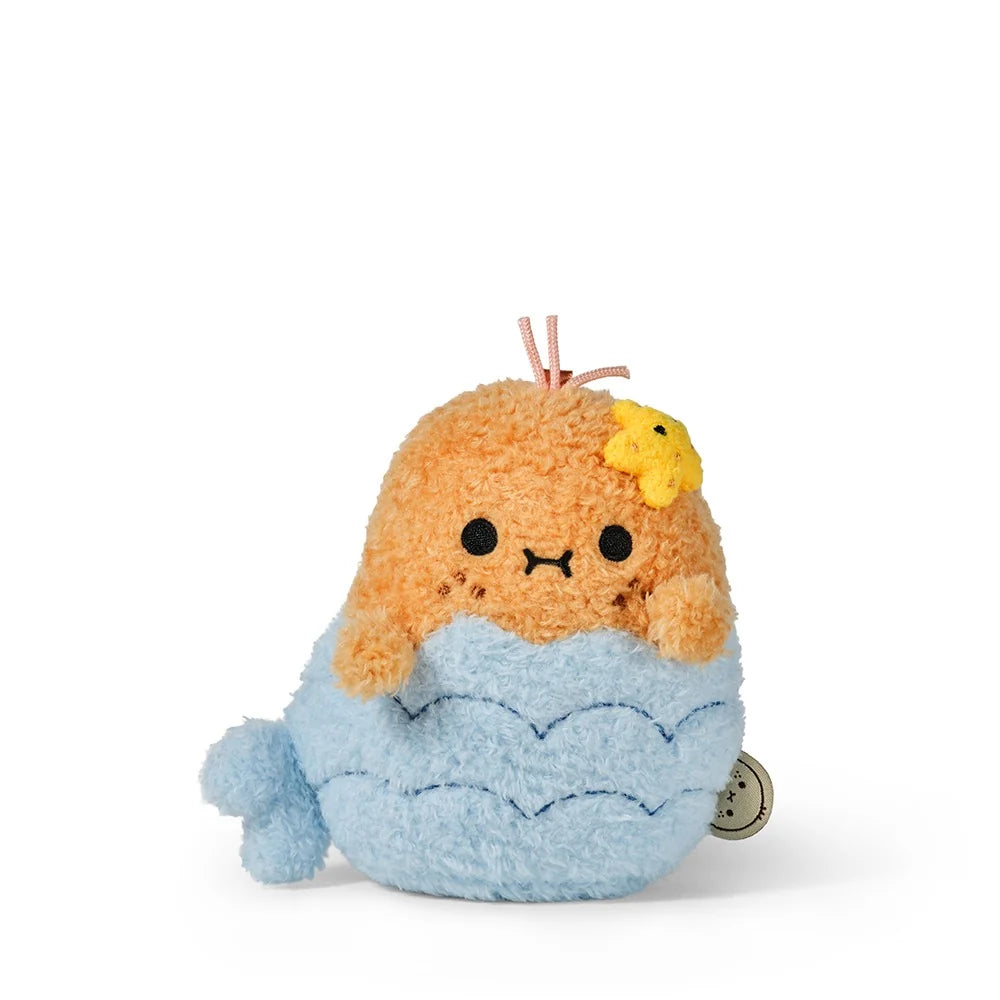 The Noodoll Ricespud Mermaid is a charming orange seal plush toy with a yellow star on its head, adorned in a light blue mermaid tail and detailed with embroidered facial features.