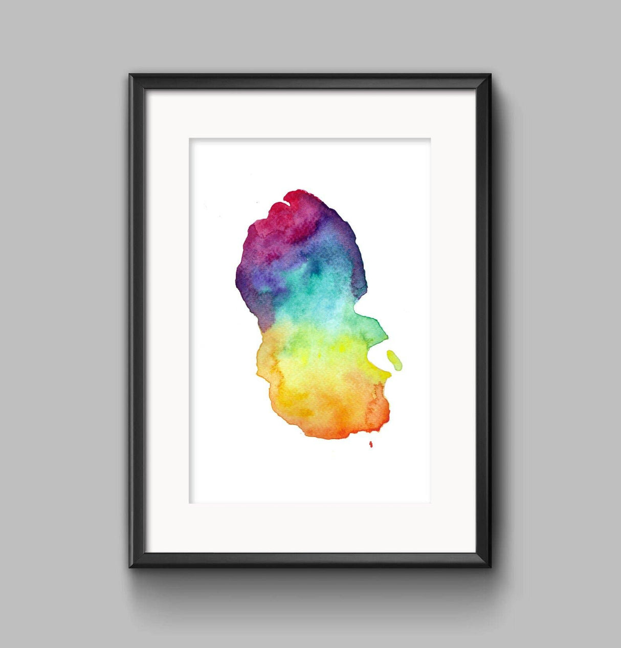 Arran Map Print A4—a framed abstract watercolor art piece inspired by Scottish landscapes, featuring vibrant red, purple, blue, green, and yellow on white, showcased against a light gray wall.