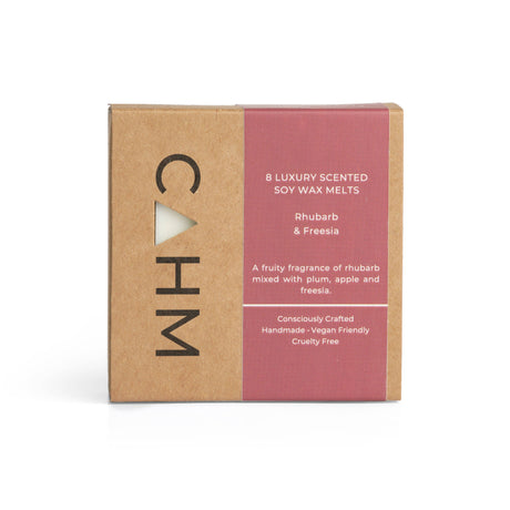 The Rhubarb & Freesia Soy Wax Melt Gift Box, a square brown and red "CAHM" package, holds 8 handcrafted soy wax melts. It offers a long-lasting rhubarb and freesia scent with plum and apple notes. The box is handmade, vegan-friendly, and cruelty-free.