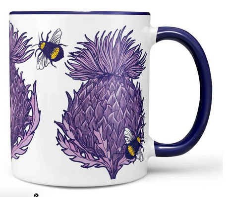 The Lilac Scottish Thistle Chunky Mug features a dark blue handle and detailed lilac and purple thistles with yellow-and-black bumblebees—perfect for enjoying your morning brew.