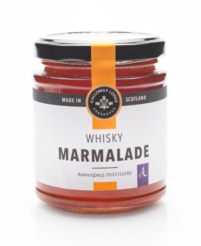 A glass jar of Whisky Marmalade with an orange label and black lid. The label reads "Made in Scotland" and "Annandale Distillery," showcasing its Scottish whisky marmalade heritage.
