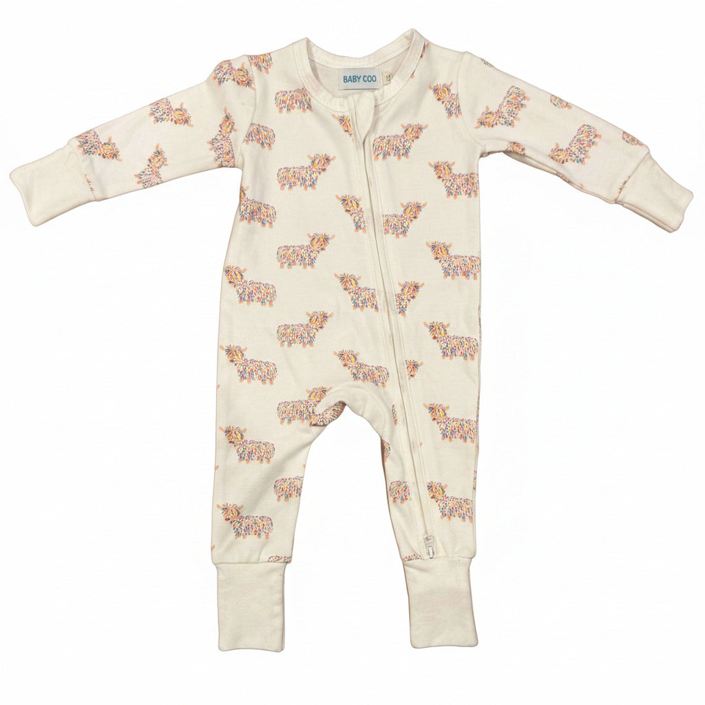 Baby onesie with highland cow pattern on a white background