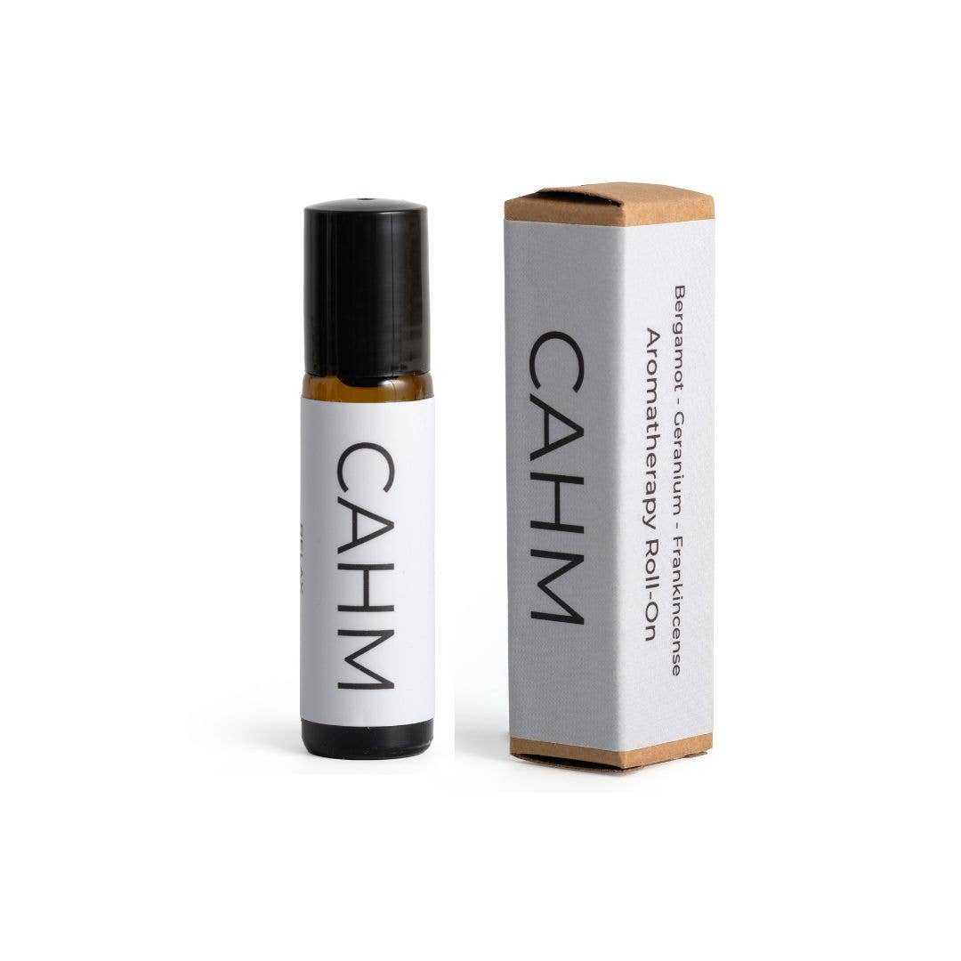 A small "CAHM" RELAX Aromatherapy Oil Roller stands by its matching box, featuring calming scents of bergamot, geranium, and frankincense. The minimalistic design has a white background with black text and is housed in eco-friendly packaging.
