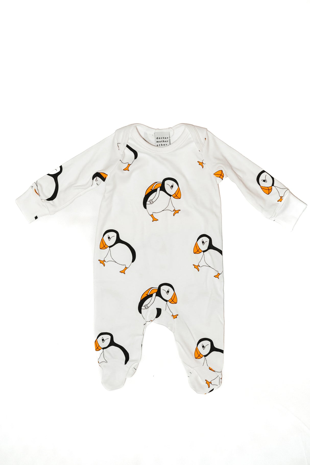 White baby onesie with long sleeves, made from 100% cotton and featuring a repeating pattern of adorable illustrated Highland cows in brown and white. The cute Highland Cow Baby Sleepsuit is displayed flat on a white background.