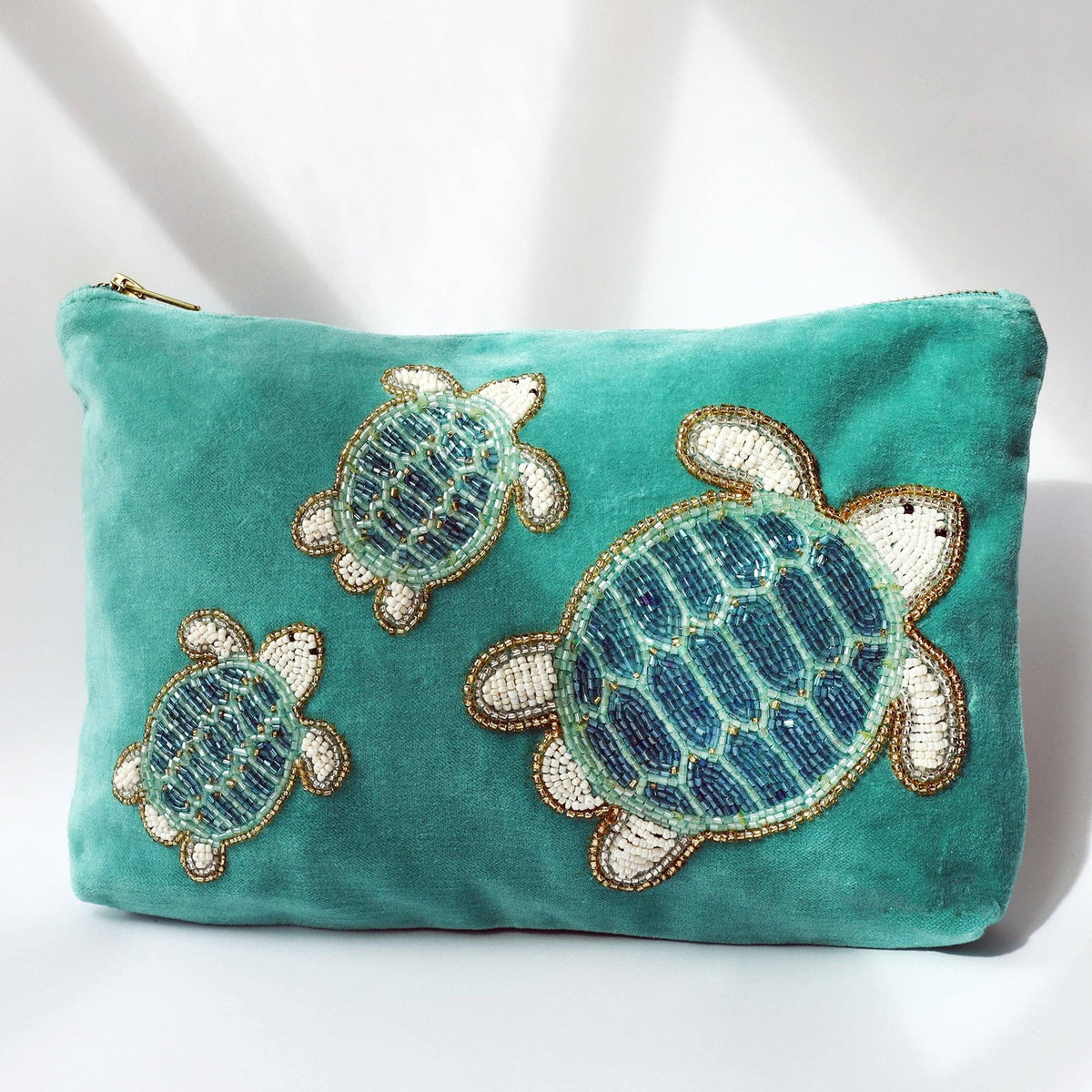 Turquoise velvet pouch bag with beaded turtles by Cream Cornwall