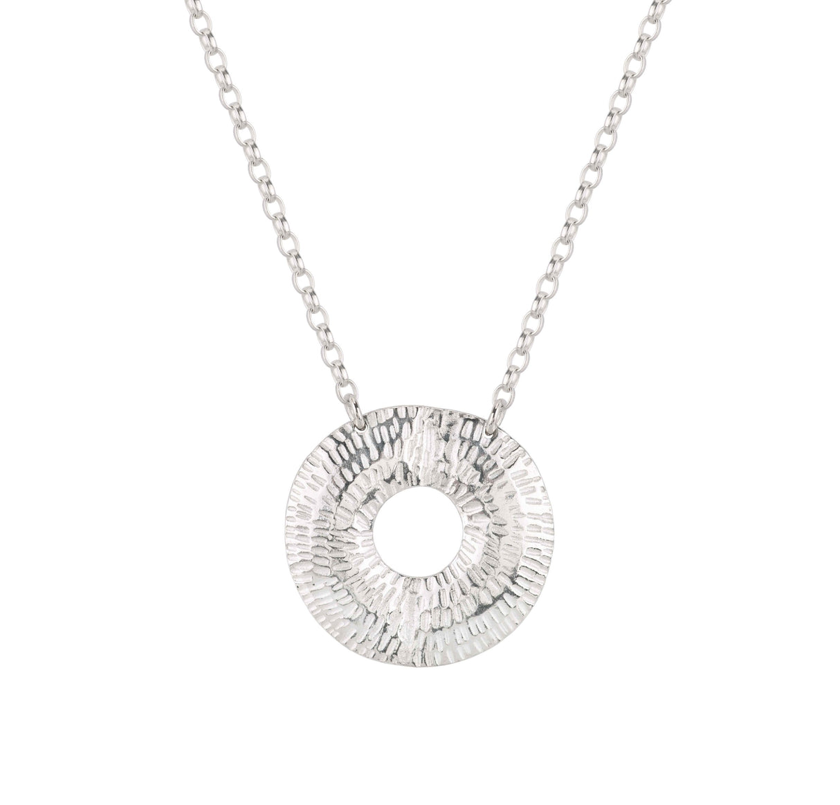 The Torus Small Necklace by Caitlin Hegney showcases a textured silver pendant with a circular cutout on a delicate chain. Handcrafted and sophisticated, it is displayed against a plain white background.