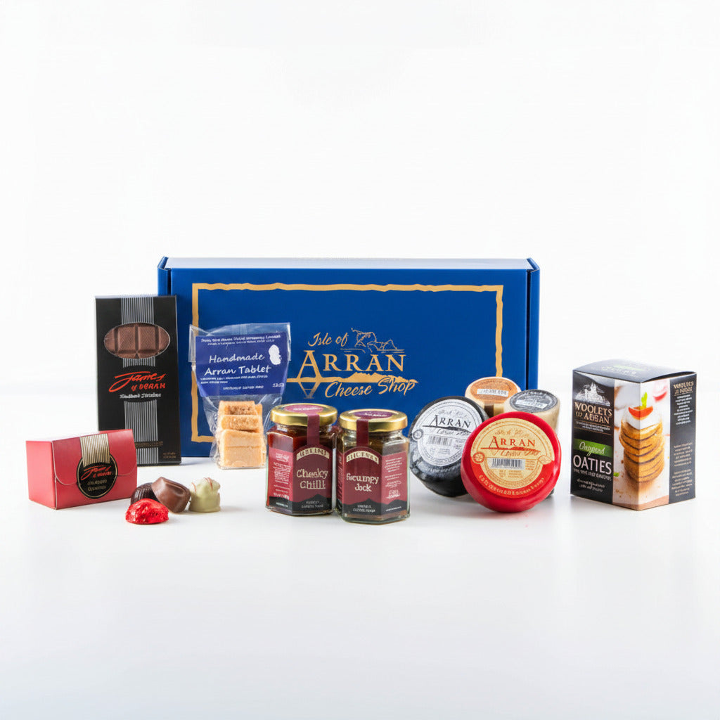 A gift box from Isle of Arran Cheese Shop containing oatcakes, chutney, cheese, and chocolates, all displayed in front of a maroon box.