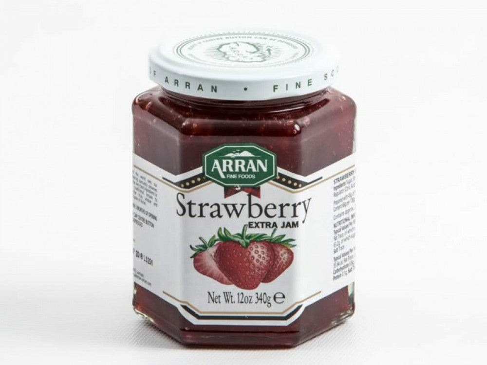 A hexagonal glass jar of Arran Fine Foods Strawberry Extra Jam with a white lid and a label featuring strawberries and product details, set against a plain white background.