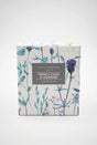 A square Gisela Graham French Cade and Lavender Candle box decorated with blue and purple botanical illustrations, featuring a central label.