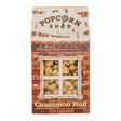 A box of Cinnamon Roll Popcorn Shed, handcrafted in the UK and featuring a charming brick house design with a window displaying delicious caramel popcorn, highlights that it is gluten free, all natural, and boasts a spiced cinnamon caramel flavor.