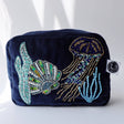 Navy velvet cosmetic bag with beaded jellyfish by Cream Cornwall