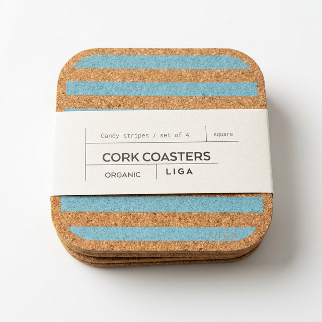 Set of 4 Blue Candy Stripe Cork Coasters, presented as a stack of four square coasters with blue horizontal stripes, wrapped in a paper band labeled “Cork Coasters.”