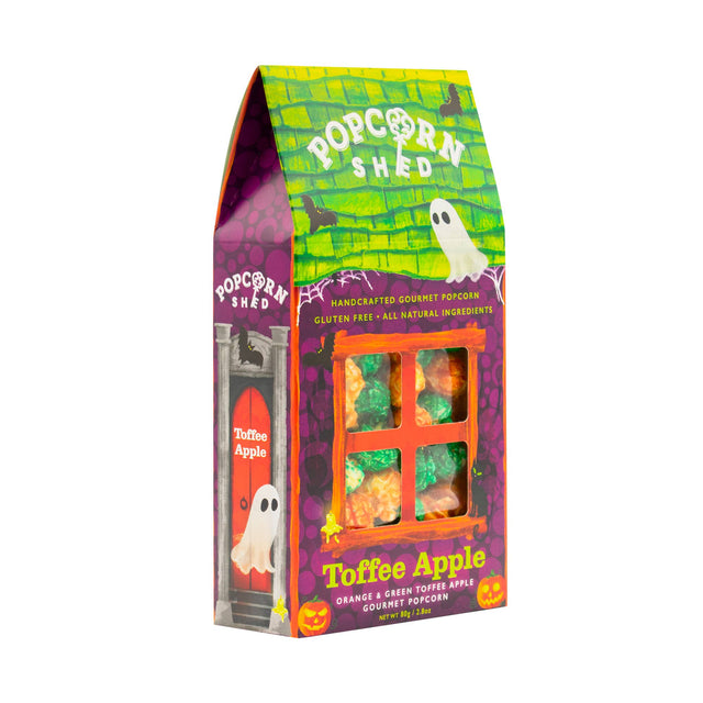 A festive box of Toffee Apple Popcorn Shed popcorn is the ideal Halloween snack, showcasing orange and green pieces with ghost decorations and a vibrant Halloween theme, clearly marked as gluten-free and all natural.