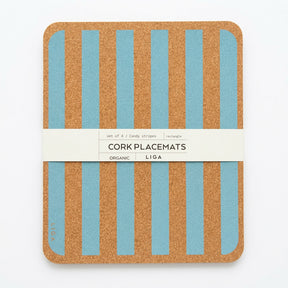 A stack of four rectangular Blue Candy Stripe Cork Placemats with blue vertical stripes, held together by a paper band labeled “CORK PLACEMATS.”
