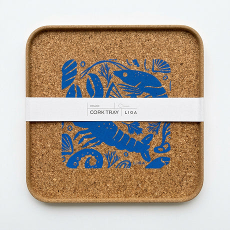 Square organic Seafood Platter Cork Serving Tray featuring a blue illustrated pattern of shrimp and shells, wrapped in a paper band labeled “Cork Tray.”