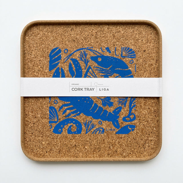 Square organic Seafood Platter Cork Serving Tray featuring a blue illustrated pattern of shrimp and shells, wrapped in a paper band labeled “Cork Tray.”
