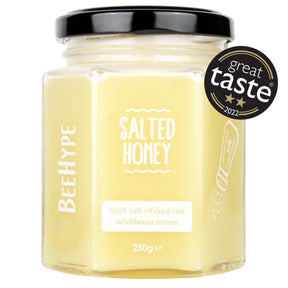 BeeHype Salted Honey comes in a hexagonal glass jar with a black lid. The label says "Rock salt infused raw wildflower honey, 250g." It’s dairy free, a caramel spread alternative, and features the Great Taste 2022 award badge.