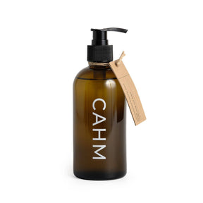 A refillable glass vessel with a black pump, labeled "CAHM" and a brown paper tag, holds Atacama Hand & Body Wash | Hand Wash | Shower Gel in the signature Atacama fragrance, shown on a white background.