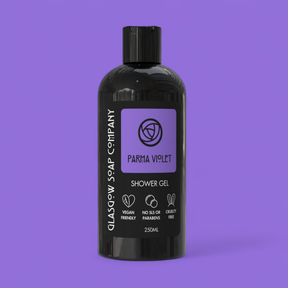 A black bottle of Parma Violet Shower Gel from Glasgow Soap Company rests on a purple background. The 250ml label notes its vegan, cruelty-free formula, and that it contains no SLS or parabens.