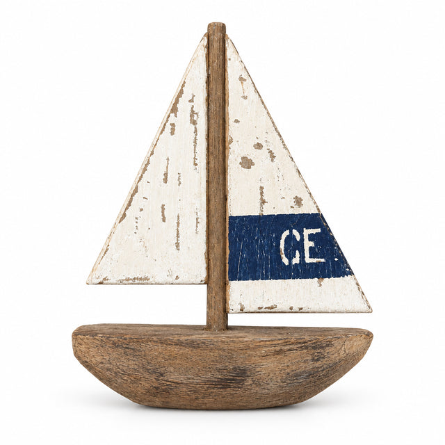 A Batela Wooden Sailboat featuring a distressed white sail with a blue horizontal stripe and the letters “CE,” perfect for coastal home accessories.