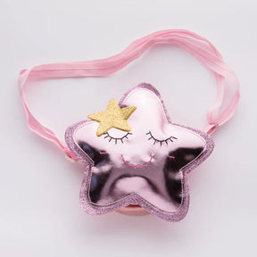 The Children’s Star Bag is a small, shiny pink accessory featuring a smiling face with closed eyes, a gold star accent, and an adjustable strap—perfect for kids.