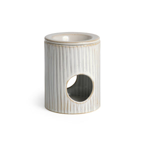 The Handmade Ceramic Wax Melt Burner features vertical ridges, a round front opening, and a shallow top dish—an elegant accessory for holding oil or wax in your home.
