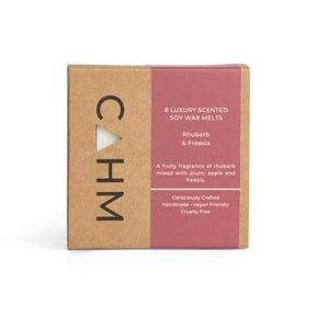 The Rhubarb & Freesia Soy Wax Melt Gift Box, a square brown and red "CAHM" package, holds 8 handcrafted soy wax melts. It offers a long-lasting rhubarb and freesia scent with plum and apple notes. The box is handmade, vegan-friendly, and cruelty-free.