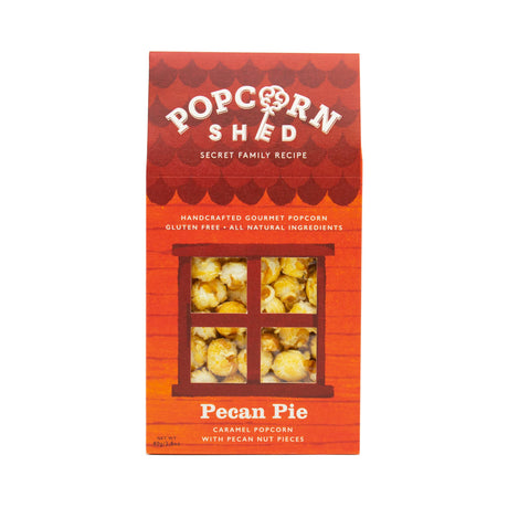 A red box of Pecan Pie Gourmet Popcorn Snack Box, featuring a window design that reveals the delicious pecan caramel popcorn inside. The label highlights that it is gluten-free, handcrafted popcorn with pieces of pecan nuts.