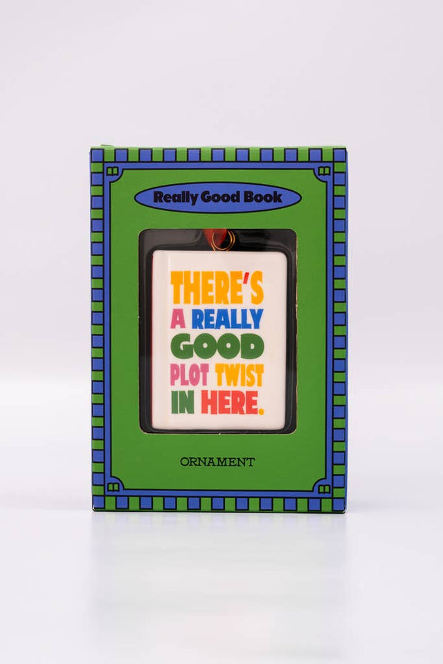 A ban.do Ornament, Book in a green and blue box, featuring the text “There’s a really good plot twist in here.”