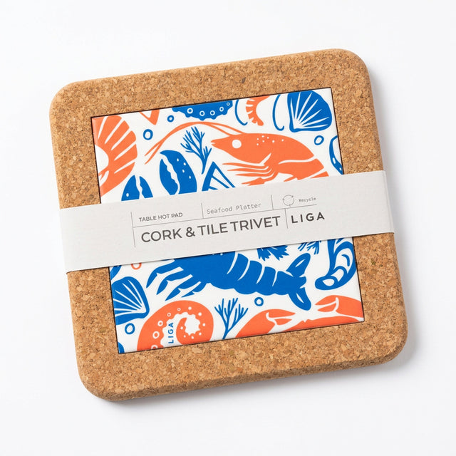 Seafood Platter Cork and Tile Trivet featuring a square cork and earthenware design with a central seafood print in blue and orange, secured with a paper band.