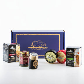 The Simply Arran Hamper features Isle of Arran cheese products, including Oak Smoked Cheddar rounds and oatcakes, accompanied by chutney, all tastefully arranged in a branded maroon gift box.