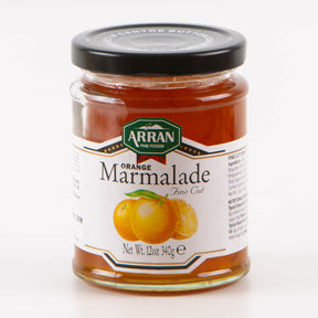 A jar of Fine Cut Orange Marmalade, crafted in traditional style by Arran Fine Foods, features a vibrant illustration of orange and lemon slices. With a net weight of 12 oz (340g), it is elegantly sealed with a black lid.