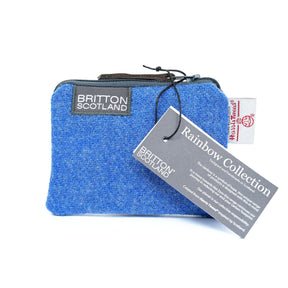 The Rainbow Harris Tweed Purse features authentic blue Harris Tweed, product tags, and a “Rainbow Collection” label—a stylish accessory that highlights true Scottish craftsmanship.