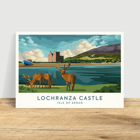 Catriona Tod Lochranza Print features Lochranza Castle on the Isle of Arran, with three deer by the shore, a blue boat, green hills, and a partly cloudy sky in the background.