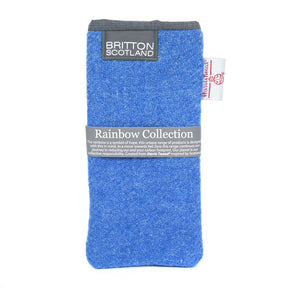 The Rainbow Harris Tweed Glasses Pouch features blue Scottish fabric from the Rainbow Collection, a gray top edge, front label, and white side tag—crafted from eco-friendly recycled materials.