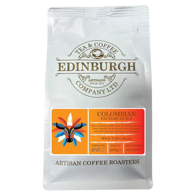 A 200g bag of Columbian coffee beans from Edinburgh Tea & Coffee Company. This traditional coffee features an orange label adorned with a vibrant mask illustration and product details, emphasizing the signature caramel notes characteristic of Huila coffees.