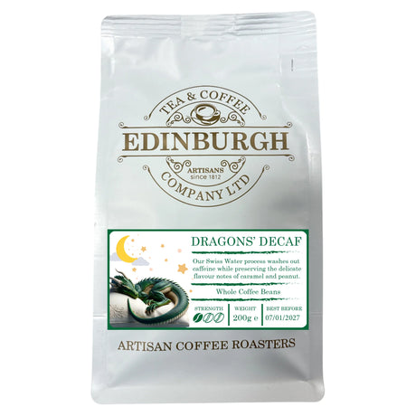 A 200g white bag of Dragons Decaf from Edinburgh Tea & Coffee Company, adorned with a dragon illustration and a label emphasizing the Swiss Water decaffeination process. This decaf coffee features subtle caramel and peanut notes, with a best before date of 07/01/2027.