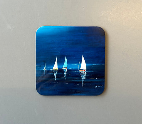 A small CHARLES HERBERT COASTER by Charles Herbert depicts several sailboats with white sails gliding on a calm, dark blue sea at night. The sailboats are reflected in the water under a serene night sky.