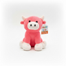 The Hairy Coo Kids Plush Toy is a pink plush cow with white horns, feet, and snout, black eyes, and a colorful "Hairy Coo Kids" tag. It sits upright against a plain white background.