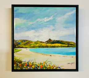 Brodick Beach Ceramic Tile features vibrant flowers, sandy shores, people strolling by blue waters, green hills, and a partly cloudy sky—capturing the charm of Arran landscapes.