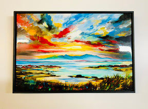 The Arran Sunset Ceramic Tile features a vibrant landscape inspired by Arran, with bold brushstrokes depicting a colorful sunset over distant mountains, calm water, and grassy shoreline, creating a dramatic and lively scene.