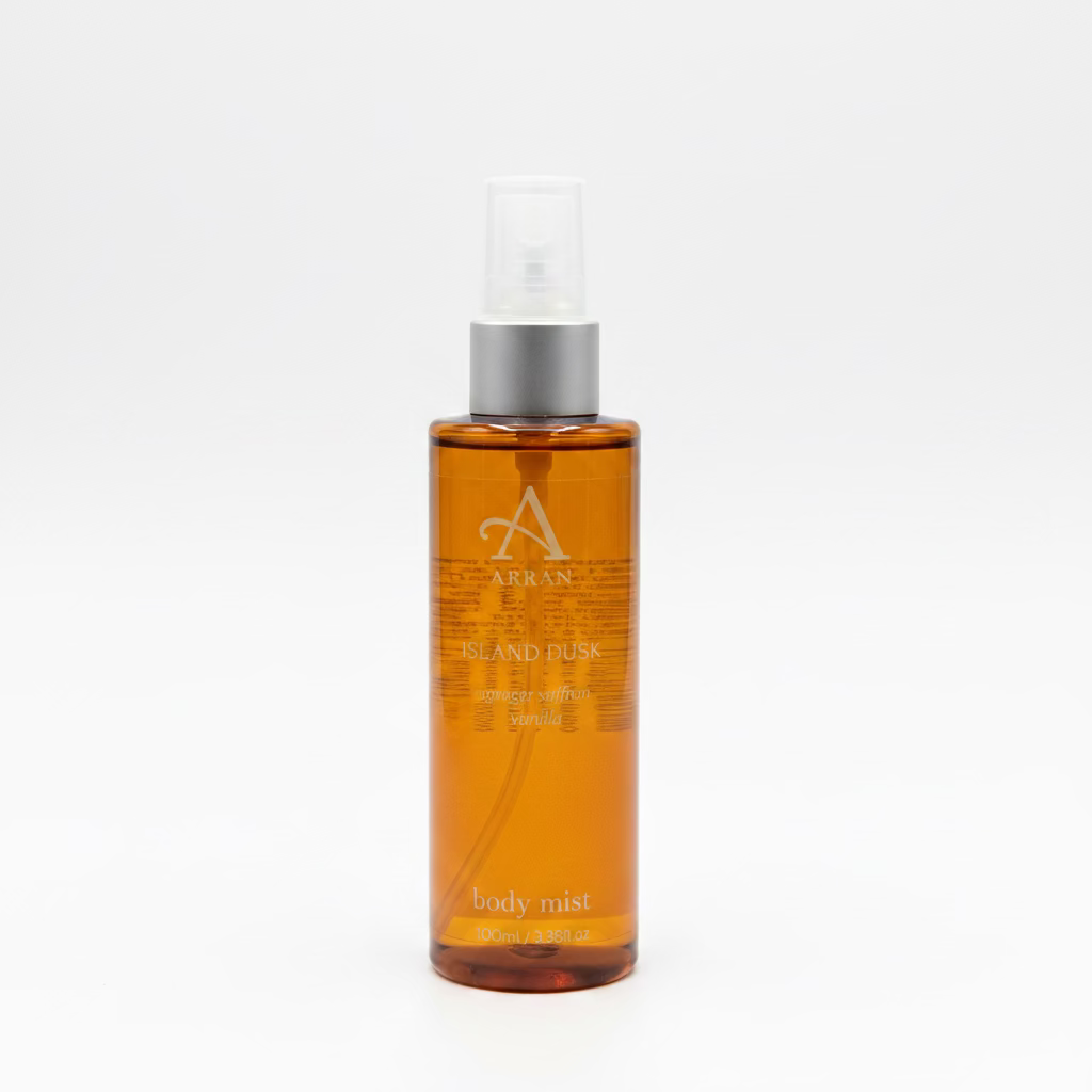 A brown spray bottle of Island Dusk Body Mist 100ml from ARRAN Sense of Scotland, inspired by the Isle of Arran and offering a captivating blend of ginger, saffron, and vanilla scents, is shown against a plain white background.