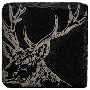 The Single Slate Coaster - Stag features a detailed sketch of a stag’s head with large antlers, etched in a contrasting light color onto a square black slate tile.