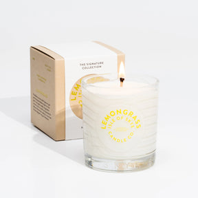 The Isle of Skye Lemongrass Tumbler Candle is a beautifully handmade Scottish soya wax candle in clear glass, labeled and presented in front of its matching yellow and white box.