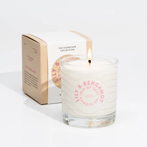 The Isle of Skye Lily & Bergamot Tumbler Candle, made from natural soya wax, sits before its matching box, showcasing the elegance and purity of handmade Scottish craftsmanship.
