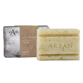 The 200g Lochranza Soap, embossed with "ARRAN," features a patchouli vetiver scent, oatmeal with small specks, and is shown beside its brown and silver packaging.
