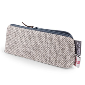 Atmosphere Harris Tweed Slim Pencil Case: rectangular, beige textured fabric with eco-friendly material, navy zipper, brown pull tab, and a side tag reading “BRITTON SOUTHARD”; shown on a white background.