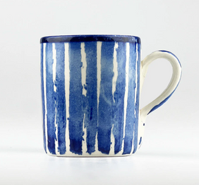 The Selbrae House Stripe Ceramic Mug features a white base with vertical blue stripes, a blue rim, and a curved handle, displayed against a plain white background.