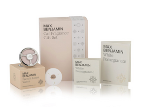 The Max Benjamin Car Fragrance Gift Set includes an in-car diffuser with French Linen Water and White Pomegranate refills, a scented card, and stylish beige and white packaging for a sophisticated driving experience.